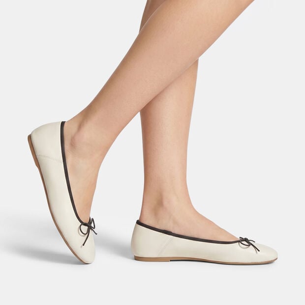 Bata women's ballerina flat with black trim and bow, White